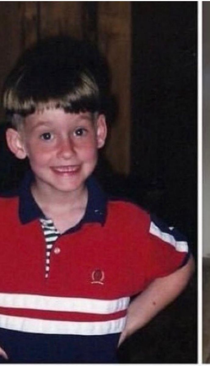 Young Tyler smiling in a red and navy polo shirt